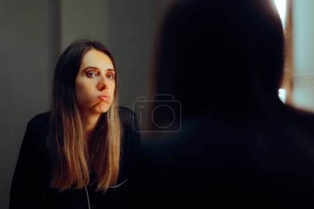 Stressed Woman Looking in the Mirror Feeling Anxious 