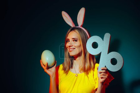 Happy Woman Holding a Huge Easter Egg and a Discount Symbol