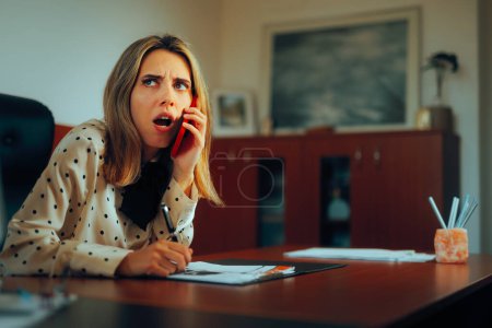 Photo for Businesswoman Talking on the Phone Getting Sensitive Information - Royalty Free Image