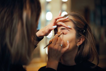 Professional Make-up Artist Applying Eyeshadow with a Brush 