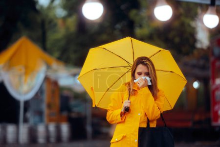 Mujer enferma sosteniendo un paraguas sonándose la nariz