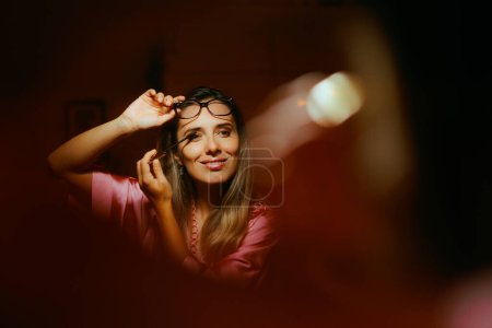 Lady Using Mascara While Wearing Eyeglasses  