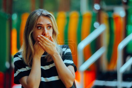 Mujer sintiéndose enferma cubriendo su boca en un parque 