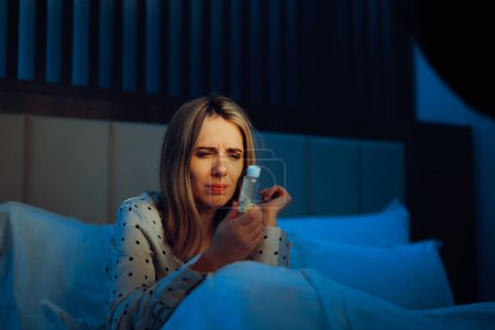 Woman taking Pills from Insomnia Reading the Label 