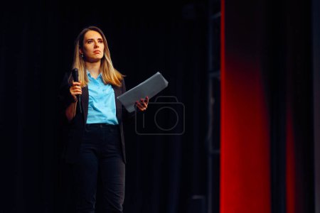Woman Reading a speech Taking Questions on Stage 