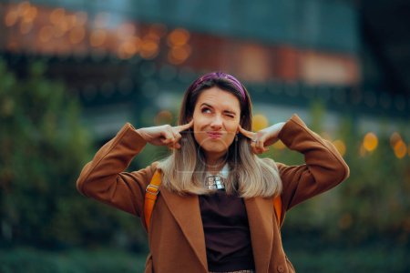 Woman Covering Her Ears Outdoors in the Big City