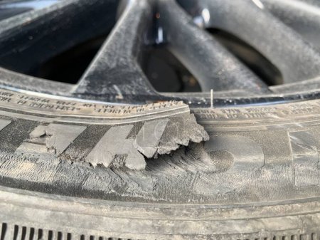 Foto de Neumático dañado. Un agujero en la rueda de un coche. Concepto: una rueda dañada necesita ser reemplazada. Región de Kiev, Irpen, 14 de marzo de 2023 - Imagen libre de derechos
