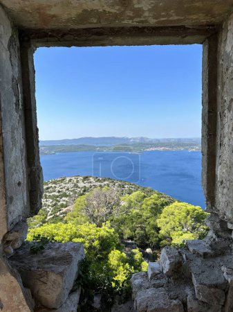 View of the sea from St. Michael's Fortress on the island of Ugljan in Croatia. Old fortress stones on a mountain overlooking the Adriatic Sea. Ancient stones of an old seaside town.