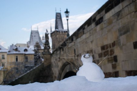 Photo for First snow in Prague, Little snowman at the Charles Bridge - Royalty Free Image
