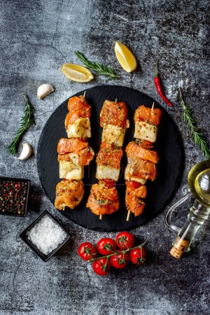 Photo for Raw salmon on skewers with lemon and herbs, close up view - Royalty Free Image