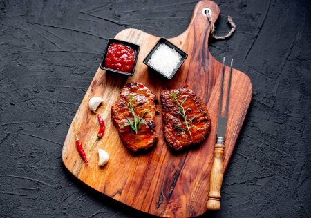 Photo for Grilled beef steaks with rosemary and spices, close up view - Royalty Free Image