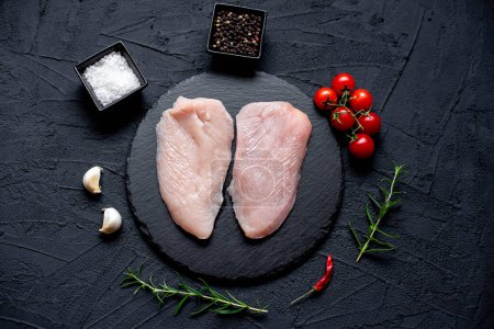 Photo for Raw chicken breast with spices and herbs, close up view - Royalty Free Image