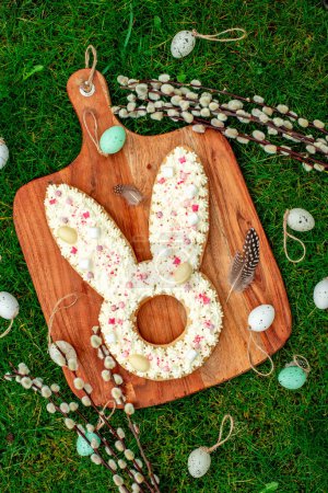 Photo for Easter rabbit shaped cake with eggs and flowers - Royalty Free Image