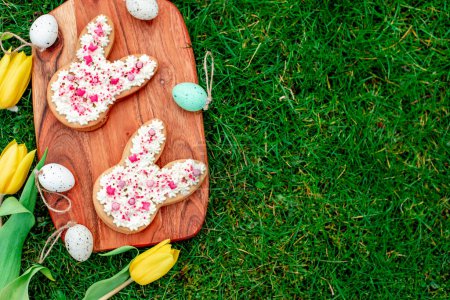 Photo for Easter rabbit shaped cookies with eggs, conceptual image - Royalty Free Image