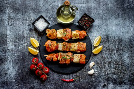 Photo for Raw salmon on skewers with lemon and herbs, close up view - Royalty Free Image