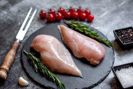 Photo for Raw chicken breasts with spices and herbs on stone background - Royalty Free Image