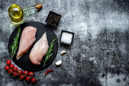 Photo for Raw chicken breasts with spices and herbs on stone background - Royalty Free Image