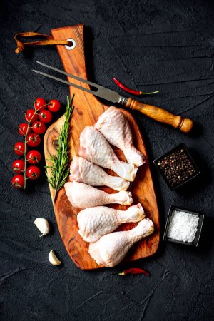 Photo for Raw chicken legs on black stone background, top view - Royalty Free Image