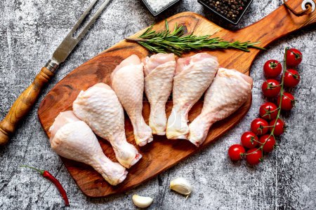 Photo for Raw chicken legs on wooden board, top view - Royalty Free Image