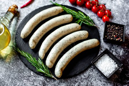 Photo for Raw german sausages on stone background - Royalty Free Image