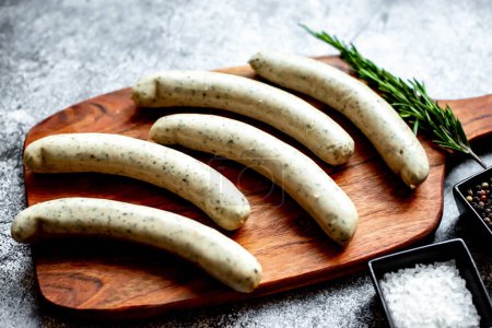 Photo for Raw german sausages on wooden board - Royalty Free Image