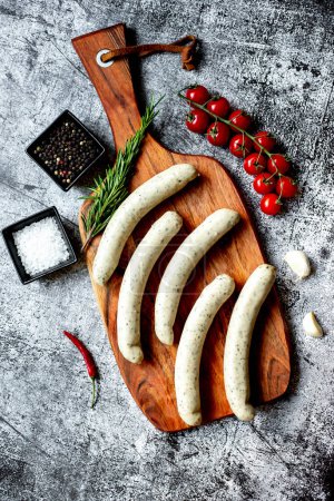 Photo for Raw german sausages on wooden board - Royalty Free Image
