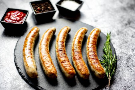 Photo for Grilled sausages on stone background - Royalty Free Image