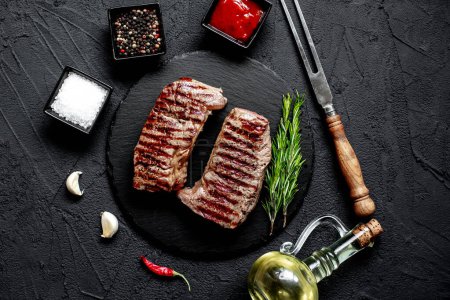 Photo for Grilled beef steak with spices and vegetables, close up view, food concept - Royalty Free Image
