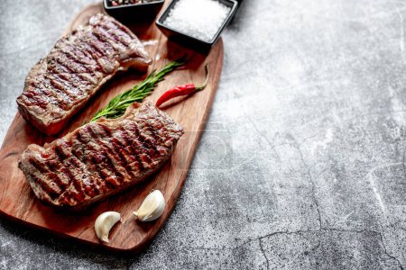 Photo for Grilled beef steak with spices and vegetables, close up view, food concept - Royalty Free Image