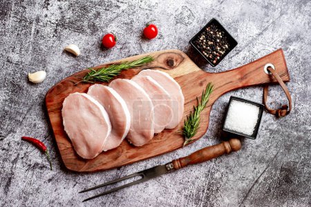Photo for Raw pork meat steaks with spices and herbs, close up view - Royalty Free Image