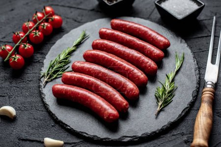 Photo for Raw sausages with rosemary and spices, close up view - Royalty Free Image
