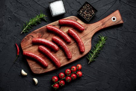 Photo for Raw sausages with rosemary and spices, close up view - Royalty Free Image
