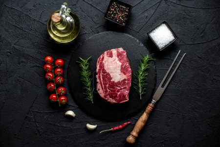 Photo for Raw beef steak with spices and herbs, close up view - Royalty Free Image