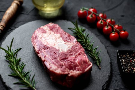 Photo for Raw beef steak with spices and herbs, close up view - Royalty Free Image