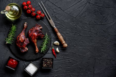Photo for Grilled chicken legs with spices and herbs on black background - Royalty Free Image
