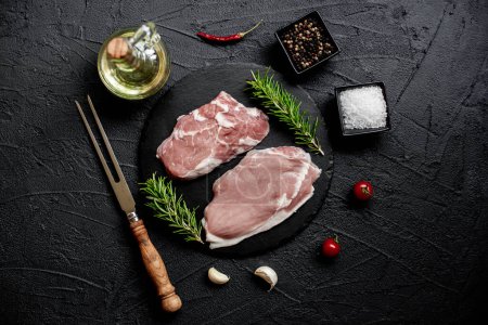 Photo for Raw pork steaks with spices and herbs, food concept - Royalty Free Image