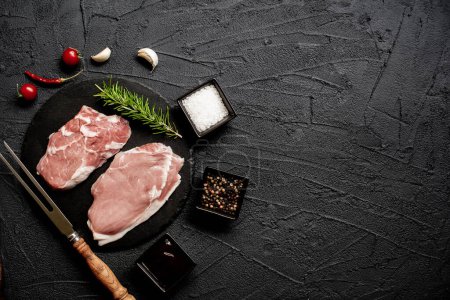 Photo for Raw pork steaks with spices and herbs, food concept - Royalty Free Image