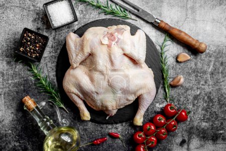 Photo for Whole raw chicken on a stone background - Royalty Free Image