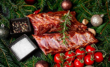 Photo for Raw marinated pork ribs with spices on stone background with Christmas decorations - Royalty Free Image