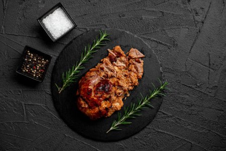 Photo for Pork cooked in the oven on a stone background - Royalty Free Image