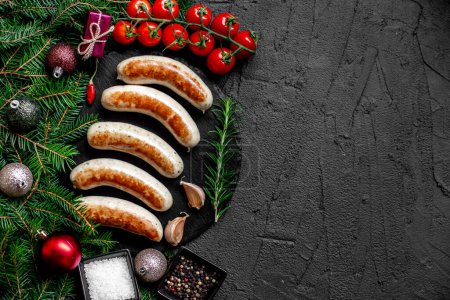 Photo for Christmas background, German grilled sausages on stone background - Royalty Free Image