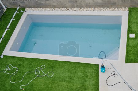 Photo for Pool cleaning of the dirty water after the winter season - Royalty Free Image