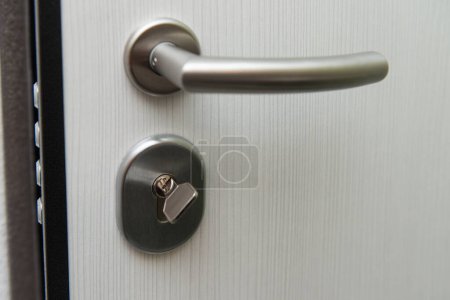 Photo for Modern Metal Key and Key Hole and Door - Very Sturdy Steel Door - Royalty Free Image