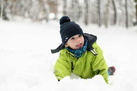 Photo for Boy Having Fun Playing With Fresh Snow During Vacation in Woods - Royalty Free Image