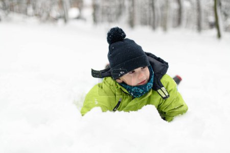 Photo for Boy Playing in Snow in the Woods While on Vacation - Royalty Free Image