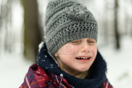 Photo for Little Girl Having Sad Time and Not Playing With Snow Outdoors During Snowfall - Royalty Free Image