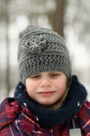 Photo for Girl Having Sad Time With Fresh Snow During Vacation in Woods - Royalty Free Image
