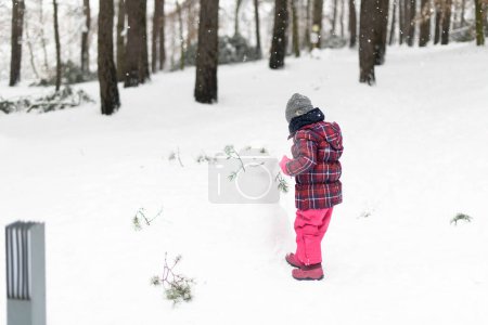 Photo for Girl Playing in Snow in the Woods While on Vacation - Royalty Free Image