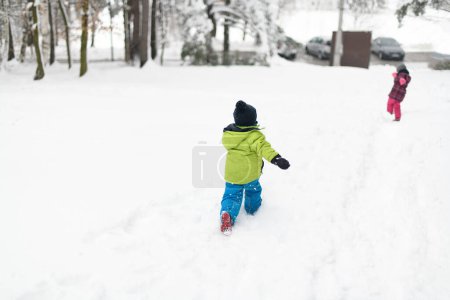 Photo for Two Adorable Young Siblings Having Fun Together in Beautiful Winter Park - Royalty Free Image