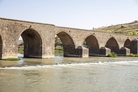 Photo for The Dicle Bridge is a historic bridge in Diyarbakr over the river Tigris in southeastern Turkey. Completed in 1065, it numbers ten arches with a total length of 178 m. - Royalty Free Image